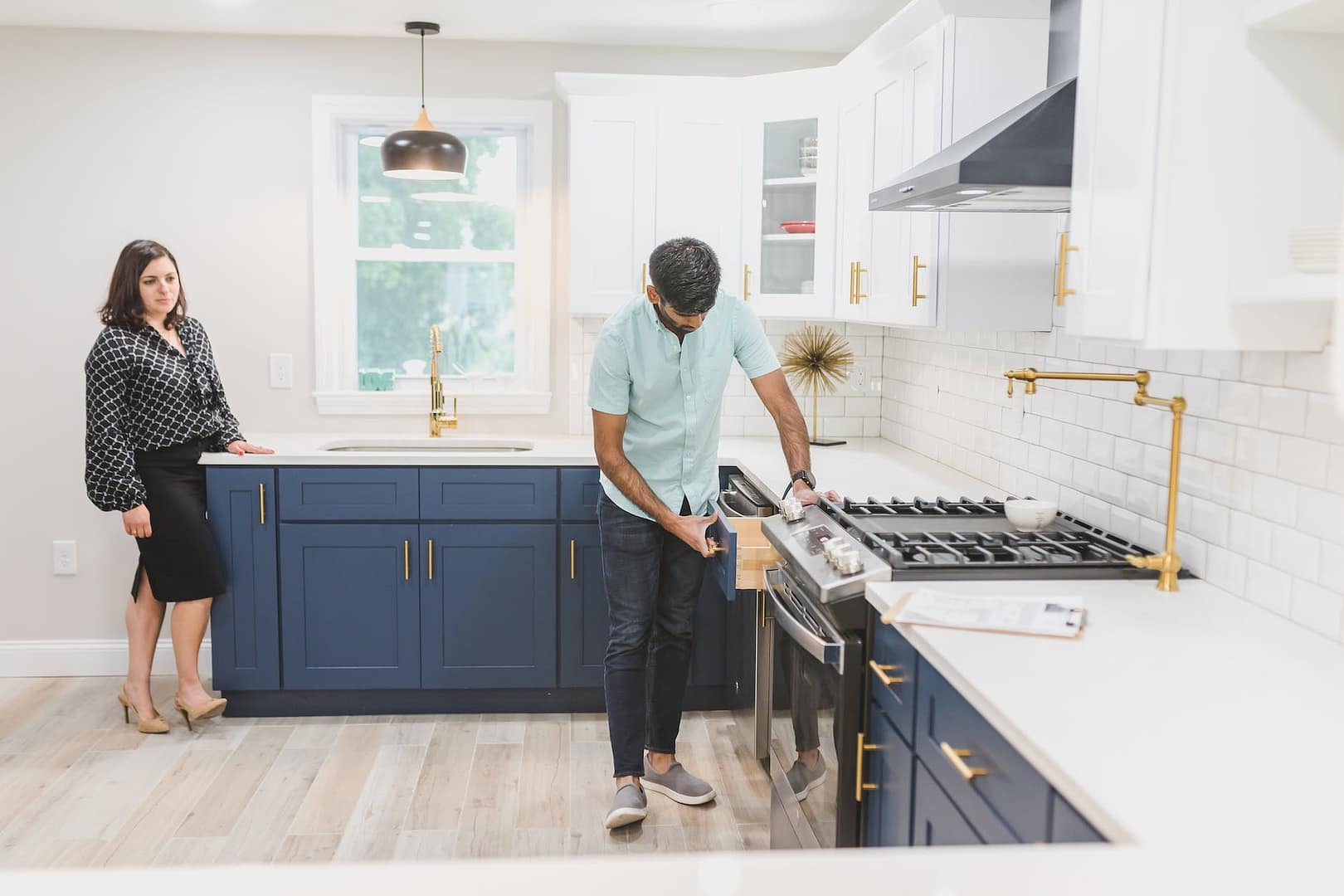 a man inspecting the kitchen drawer